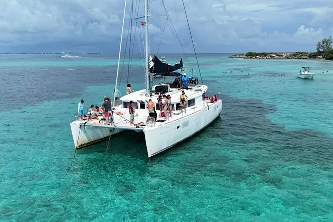 Catamaran anchored over turquoise water on a Nassau Bahamas snorkeling cruise near Rose Island