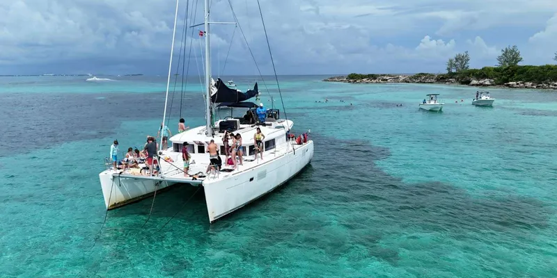 Snorkelers exploring a turquoise coral reef on a Nassau Bahamas snorkeling catamaran cruise with swimming pigs and sea turtles in Nassau