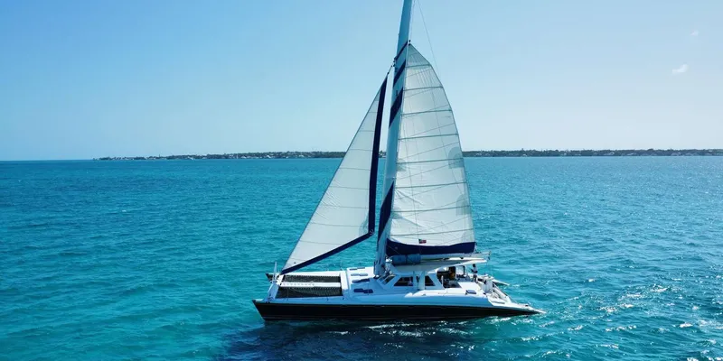 Luxury catamaran anchored over a reef on a Nassau Bahamas snorkeling cruise with swimming pigs and rum near Rose Island in Nassau